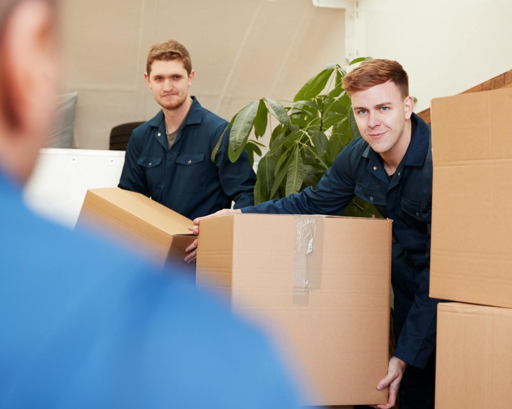 removal-company-workers-unloading-furniture-and-boxes-from-truck-into-new-home-on-moving-day-1.jpg